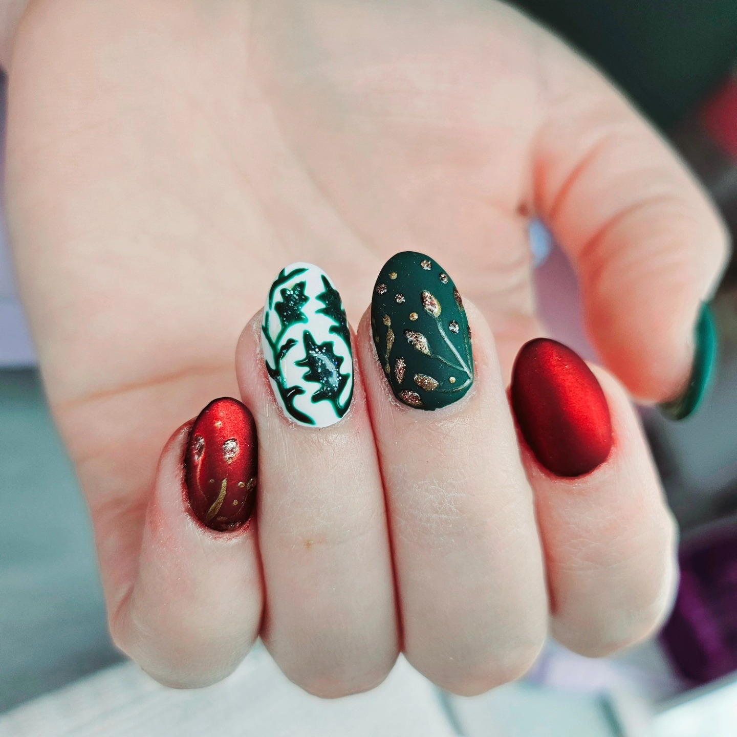 Red and green hand-painted nail art