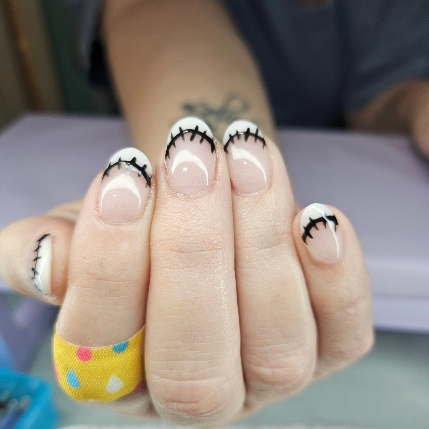 White with black eyelash nail art