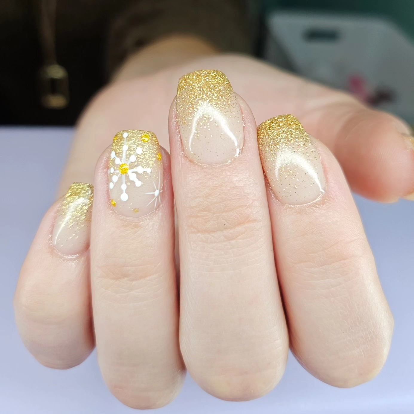 Gold glitter snowflake nails