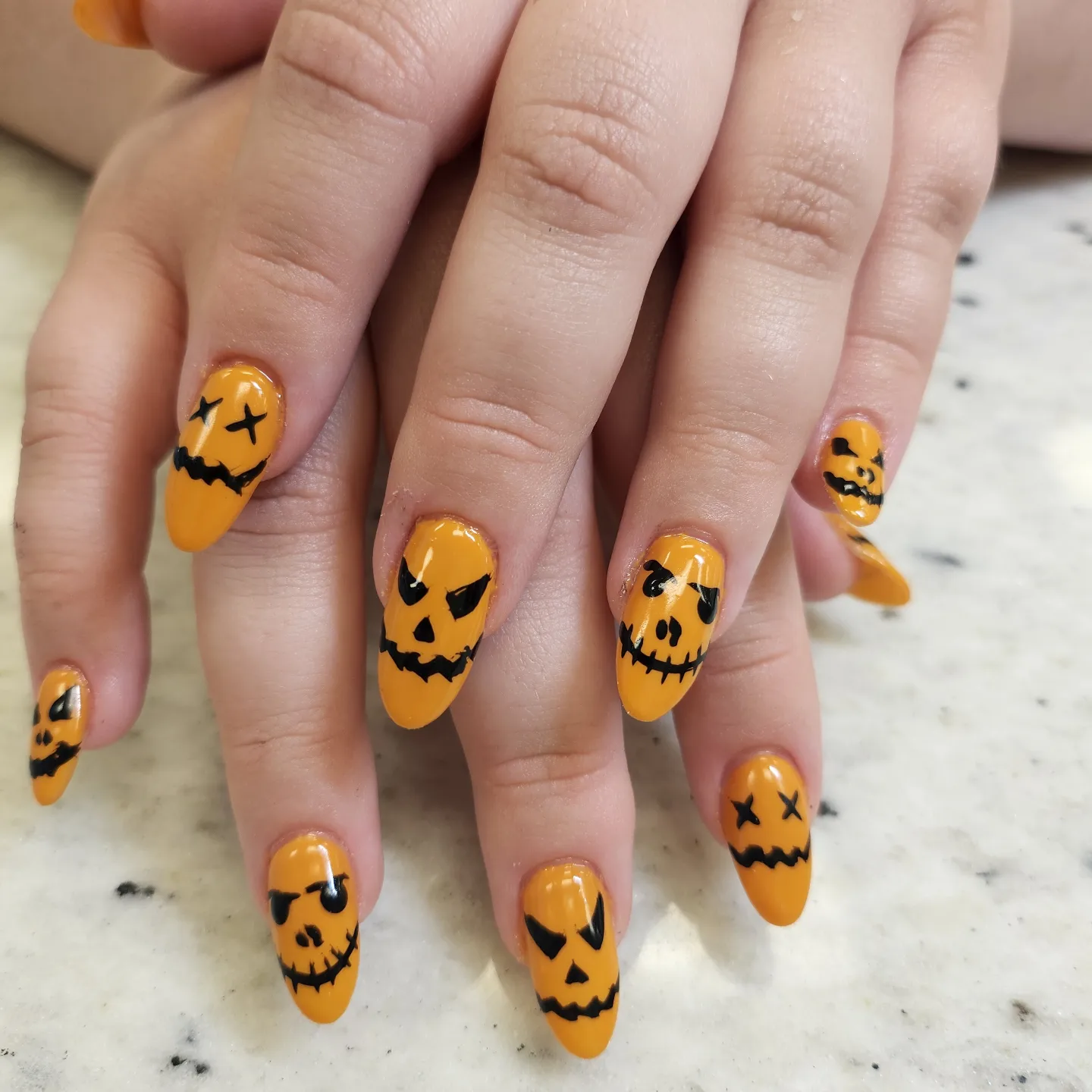Orange pumpkin face Halloween nails