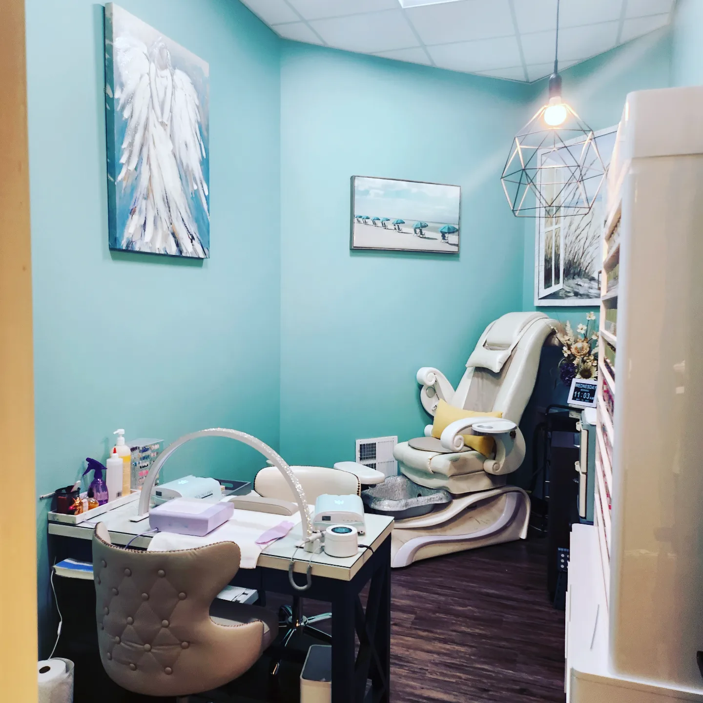 Sun's Nail Studio interior with pedicure chair, nail station, and coastal wall art